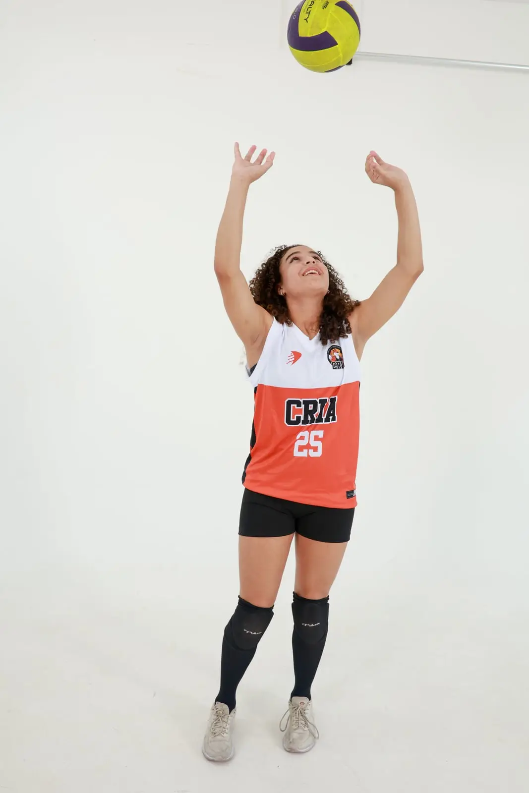 Atleta dos Crias levantando uma bola de vôlei